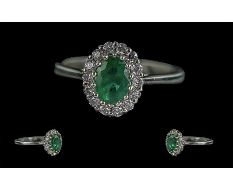 18ct White Gold Oval Emerald and Round Brilliant Cut Diamond Cluster Ring. Emerald 0.86ct. Diamonds 0.30ct.  Ring size N.