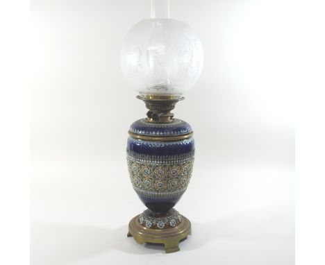 A 19th century Doulton Lambeth patent stoneware oil lamp, with stylised relief decoration on a blue ground, having Hinks pate