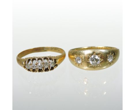 An 18 carat gold three stone diamond gypsy ring, together with an 18 carat gold five stone diamond ring (2)