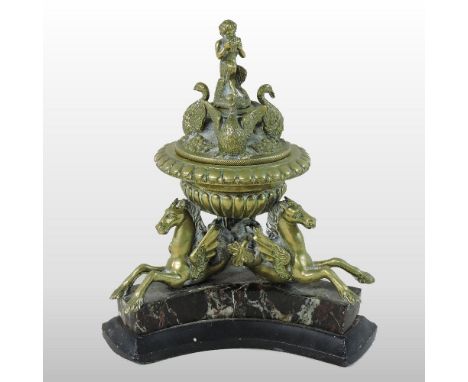 An ornate 19th century French brass inkwell, the removable lid, decorated with a fawn and three swans, on three winged horse 