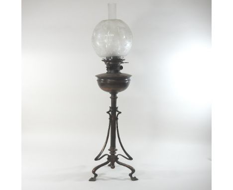 An Art Nouveau bronzed oil lamp, in the manner of W A S Benson, with a Hinks patent for Maple, London, with an etched clear g