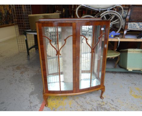 A polished two-door glazed china cabinet