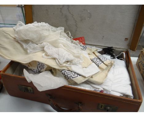 A vintage suitcase and a quantity of good vintage linen