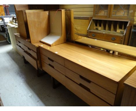 A vintage Uniflex lightwood bedroom suite comprising mirrored dressing table, chest of drawers, bedside cabinets