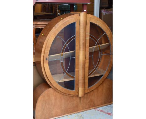 An Art Deco circular drum-type china cabinet with panelled and coloured glazed doors