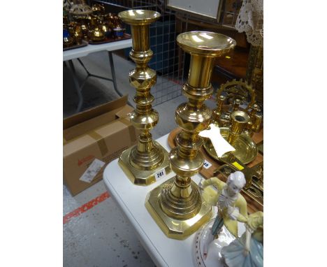 A pair of good tall brass candlestick holders