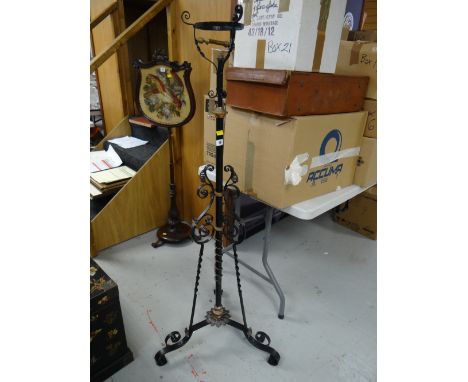An antique oil lamp standard lamp in fancy ironwork