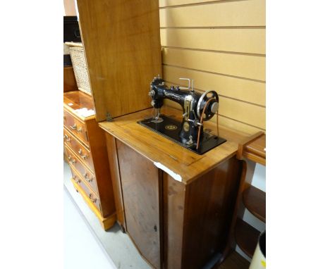 A vintage walnut cased electric sewing machine