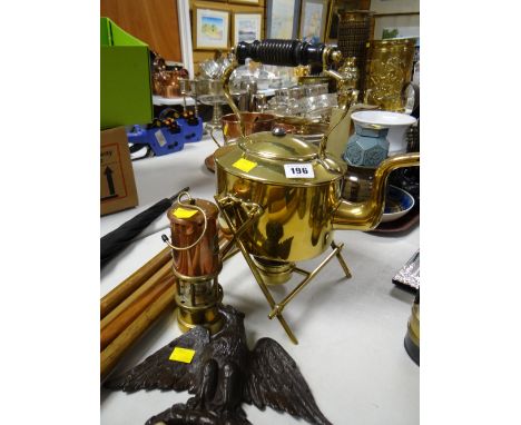 A brass spirit kettle, a carved eagle and a reproduction miners lamp