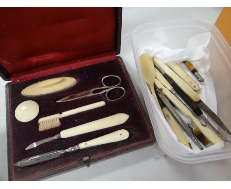 A parcel of bone handled hand tools including pen knife and button hook, a bone child's spoon etc