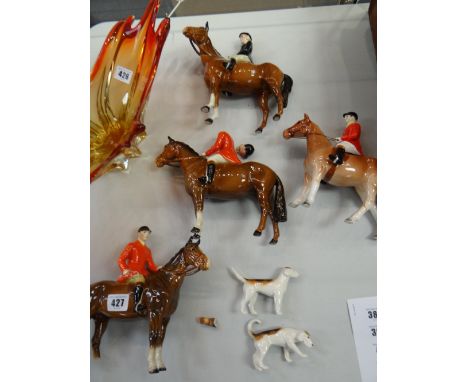 Four mounted Beswick huntsmen / women and two hunting dogs (damage to each piece)