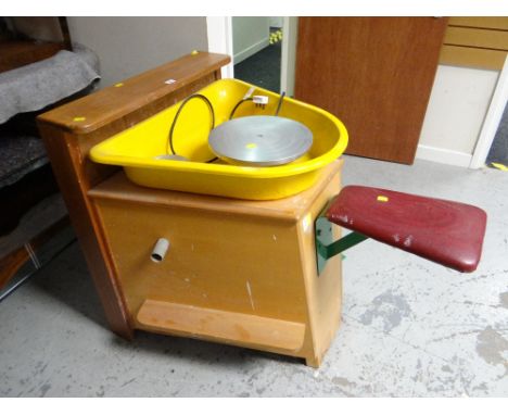 A late twentieth century potters wheel together with a large quantity of ceramic moulds and two pottery rolling tables