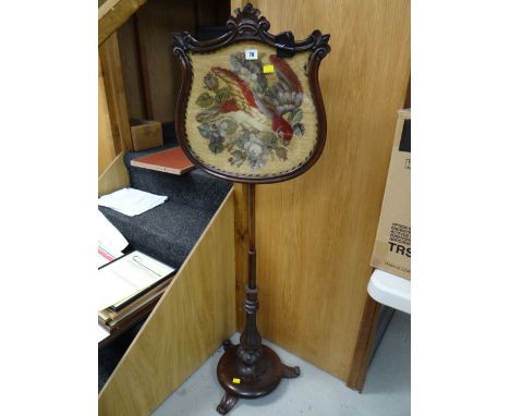 An adjustable antique rosewood pole screen with Berlin-work tapestry panel of parrot in flowers