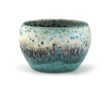 Ruskin Pottery, an experimental or trial High Fired small bowl, circa 1910, green oxide speckled with a curtain of red sang d
