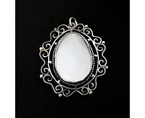 An early 20th century silver mother-of-pearl pendant, with rope-twist and scrolling openwork surround, length 4.5cm, 9.6g