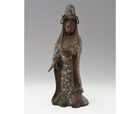 A Chinese champleve enamelled figure of Guanyin, Qing or earlier, modelled standing, holding a scroll, the hooded robe with f