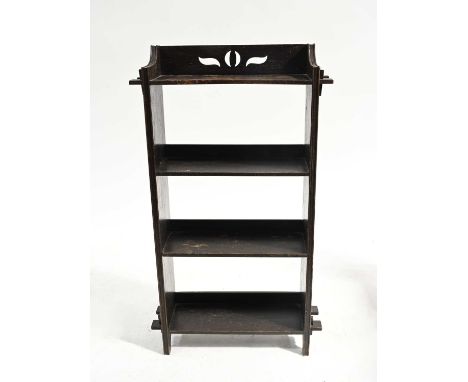An Arts and Crafts stained oak free-standing bookcase, circa 1905, fretwork frieze, four tiers with mortise and tenon joints,