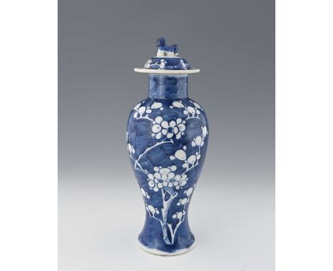 A Chinese blue and white vase and cover, inverse baluster form, painted with prunus on cracked ice, the lid with a shishi dog