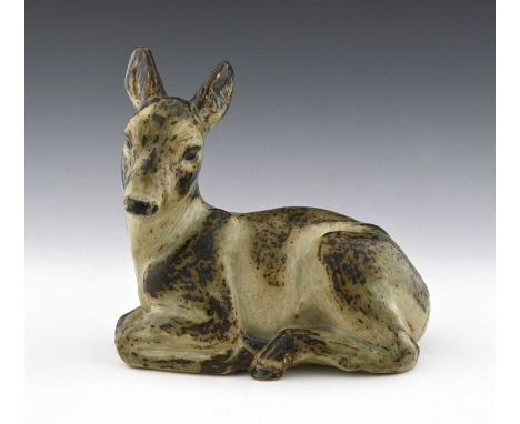 Knud Kyhn for Royal Copenhagen, a stoneware recumbent fawn, No.20506, printed, painted, and incised marks, 23cm high