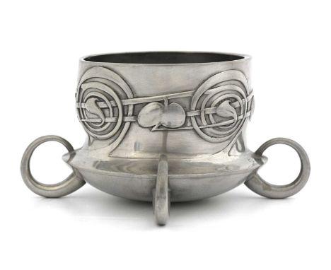 Archibald Knox for Liberty and Co, an Arts and Crafts Tudric pewter bottle coaster, model 0288, bladed bulbous form, modelled