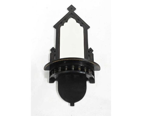 An ebonised Aesthetic Movement wall bracket, circa 1880, gothic arched mirror back, segment shelf with a ring turned spindle 