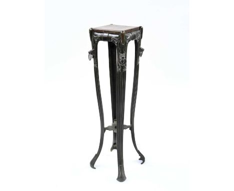 An Art Nouveau cast iron torchere, circa 1890, square inset wooden top, on four sinuous curved legs linked by an undertier, b