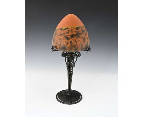 A French Art Deco wrought iron and glass table lamp, possibly Edgar Brandt for Daum, the conical domed shade in orange and bl