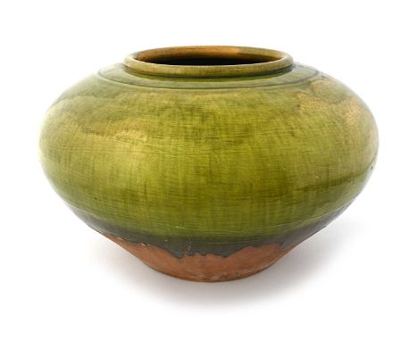 Attributed to Christopher Dresser, a large green glazed jardiniere, in the style of Linthorpe, ovoid form, 53cm diameter