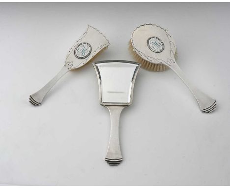 H G Murphy, an Art Deco silver three piece brush and mirror set, Falcon Studio, London 1938, Egyptian fan and paddle forms, p