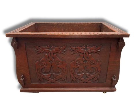 An Arts and Crafts Glasgow School wine cooler with zinc tray, cared in relief in the Iona style with Celtic knot and dragon m