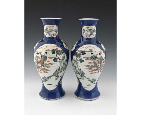 A pair of Chinese powder blue famille verte vases, Kangxi marks, inverse baluster form, decorated with ogee cartouches of mir