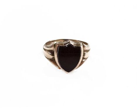A 9ct gold carnelian shield-shape signet ring, engraved 'AW' initials to inner band, 9ct hallmark (rubbed), ring size K, 4.3g