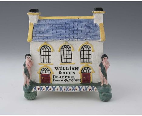A Mexborough Prattware Pottery money box, Yorkshire, early 19th Century, in the form of a Wesleyan chapel, figures to the fro