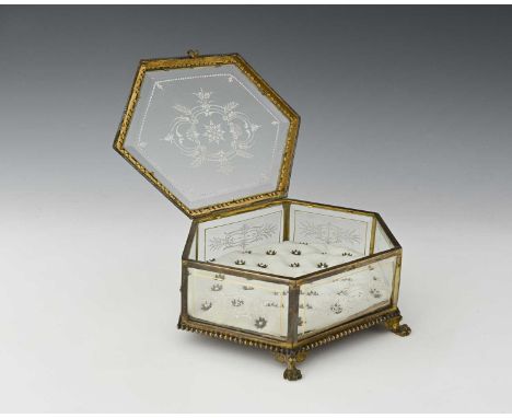 A French gilt metal and enamelled glass jewel casket, hexagonal section each bevelled pane decorated in white enamel with fol