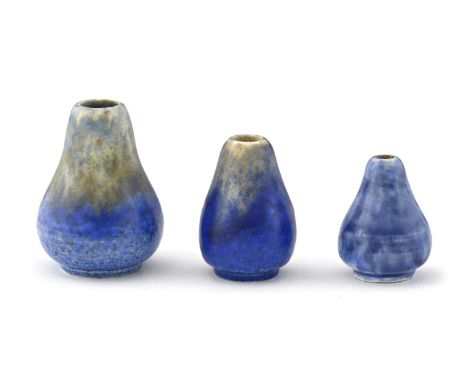 Ruskin Pottery, a graduated set of three miniature Crystalline glazed vases, circa 1930, each of gourd form, ochre and blue b