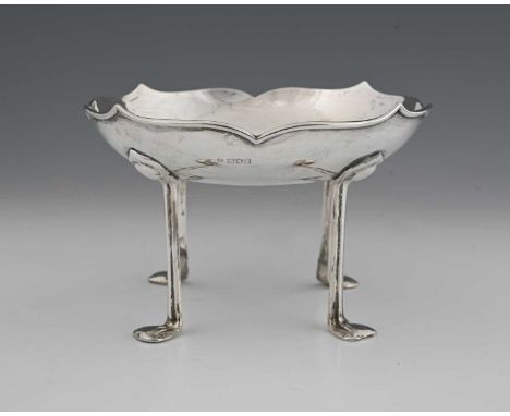 Kate Harris for William Hutton, an Arts and Crafts silver bowl, London 1906, the ogee rimmed dish supported on four organic s