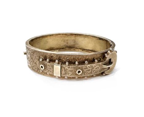 A Victorian silver gilt buckle bangle bracelet, with foliate engraved detail, hallmarks for Birmingham 1884, inner diameter 5