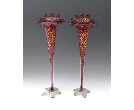 A pair of Bohemian ruby cased and enamelled glass vases, circa 1890s, slender trumpet form with wide denticulated rims, decor