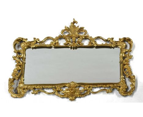 A George III carved giltwood and gesso wall mirror, in the Rococo taste, rectangular plate with an acanthus finial and openwo