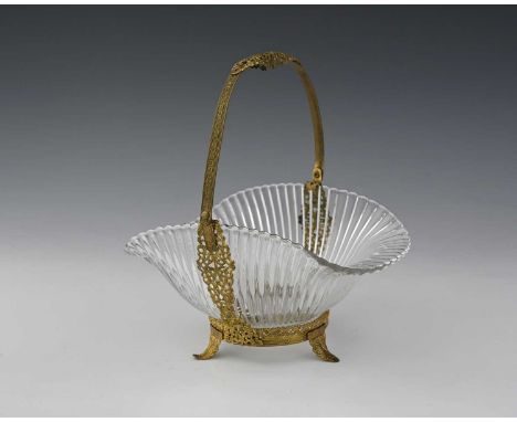 A French Palais Royal type gilt metal and glass basket, the reticulated stamped metal frame with milled Celtic knot straps an