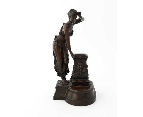 A French Art Nouveau bronze sculpture, circa 1890, modelled as a woman resting against a pedestal fountain, 29.5cm high