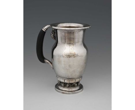 Georg Jensen, a Danish silver Grape pitcher, model 407A, designed circa 1918, planished baluster form on lobed and fruiting v