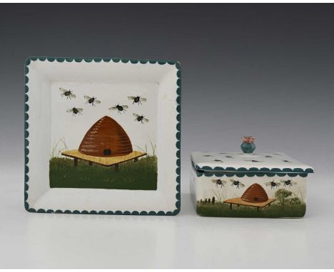 Wemyss, a beehive painted square section honey box and cover on stand, decorated with honey bees in a country landscape of fi