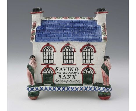A Mexborough Prattware Pottery money box, Yorkshire, early 19th Century, in the form of a Wesleyan chapel, figures to the fro