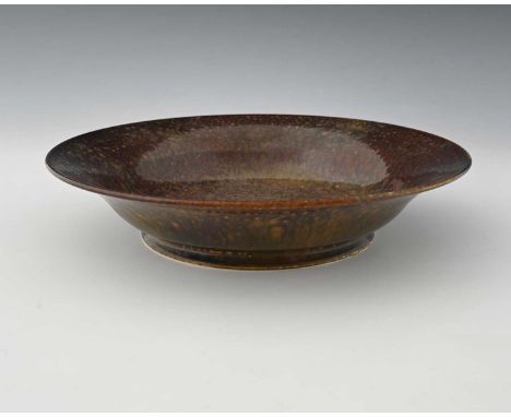 Ruskin Pottery, a Souffle type fruit skin glazed bowl, 1924, shallow footed form with everted rim, mottled ochre over rust, i