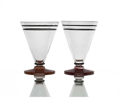 Stuart and Sons, a pair of Art Deco enamelled cocktail glasses, each of conical footed form with bladed knops, painted with c