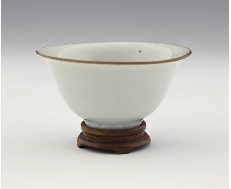 A Chinese blanc de Chine relief decorated bowl, rounded with everted rim in brown oxide, the interior slip painted under glaz
