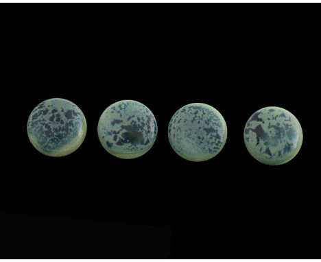 Ruskin Pottery, a set of four Souffle glazed buttons, circular with attachment loops to the back, in curdled blue over green,