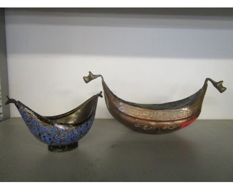 Two Islamic begging bowls (Kashkuls), one a tinned, copper example in boat form with a line of Islamic calligraphy to each si