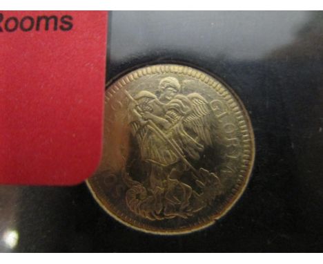 A gold replica Queen Anne touch piece coin, cased with information leaflet and card slip case 